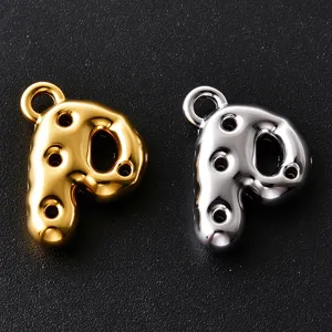 Close-up of bubble-style letter P charms in gold and silver, with loop holes on a dark backdrop