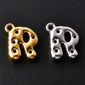 Close-up of glossy bubble-style letter R charms in gold and silver, each with a hanging loop