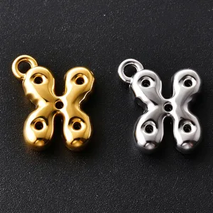 Two polished butterfly-shaped metal charms in gold and silver, each with a hanging loop and holes