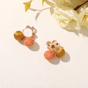 Pair of earrings with orange woven and gold fabric balls, white pom-poms and crystal flowers