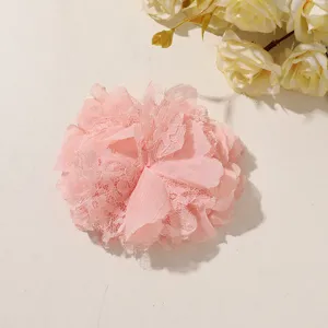 Pink layered chiffon and lace flower ornament displayed flat against a light neutral background