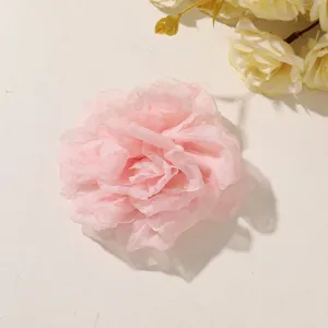 Close-up of a layered pale pink sheer flower with softly ruffled, translucent petals