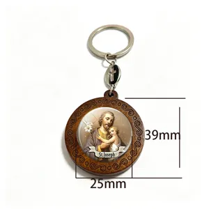 Close-up of a wooden medallion with a domed St. Joseph icon, metal cross charm and key ring