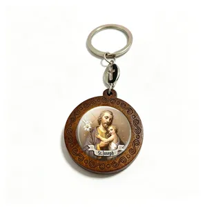 Close-up of a Saint Joseph glass medallion set in carved wood, with a small metal cross
