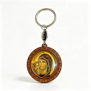 Round wooden keychain with a Marian icon under a clear cover, floral border and metal cross charm