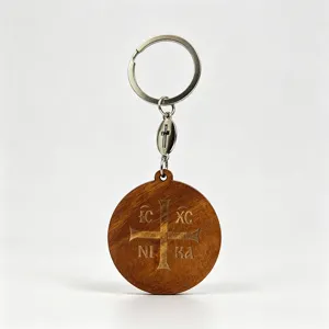 Round dark wooden keychain with engraved cross and Greek letters, silver ring and cross charm