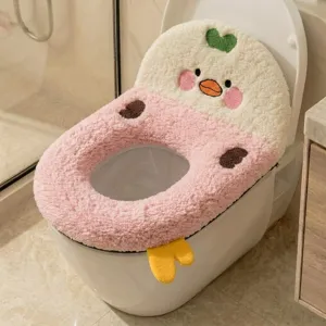 Close-up of a fluffy pink and white duck-themed toilet seat cover with embroidered details
