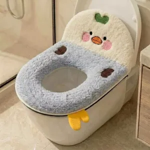 Close-up of a plush duck-face toilet seat cover with embroidered cheeks, heart, and yellow feet
