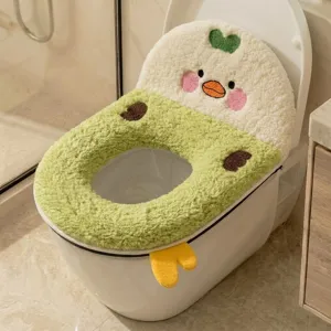 Close-up of a plush green and cream toilet seat cover with a cute duck face and yellow feet
