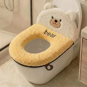 Close-up view of a yellow and cream plush bear-shaped cover fitted over a toilet bowl