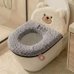 Plush bear-shaped toilet seat cover with a gray fuzzy ring, zipper and pink hanging loop