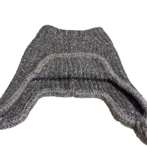 Gray knitted winter aviator hat with ear flaps, shown flat against a clean white background