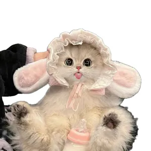 Fluffy cat wearing a pink lace bunny-ear pet hat with soft ties, shown on a white background