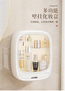 White wall-mounted organizer with clear front panel and drawer, displaying cosmetics on a beige wall