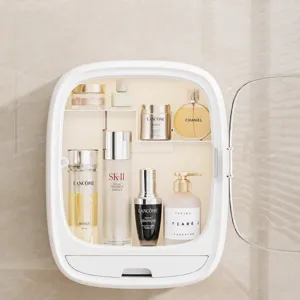 White wall-mounted cosmetic organizer with clear flip cover, divided shelves and skincare bottles