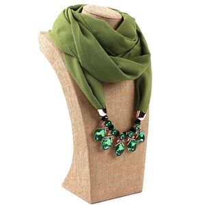 Detail of olive green chiffon scarf necklace with faceted green gemstone pendant