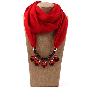 Detail of red chiffon scarf integrated with luxury red crystal bead necklace design