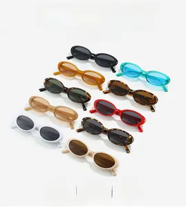 Flat lay of retro oval small frame sunglasses in multiple colors and 90s trendy styles