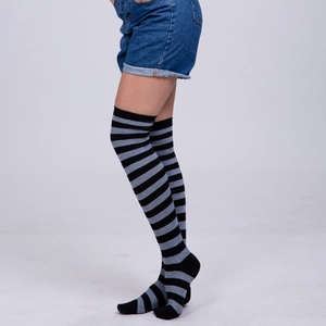 Detail view of black and grey striped over-the-knee socks showing knit texture and fit
