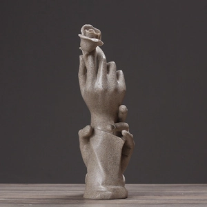 Modern resin sculpture of hands holding a rose with a textured stone finish for home decor