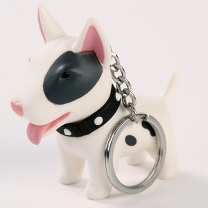 Close-up of a white Bull Terrier dog keychain with black patches and a silver keyring