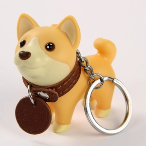 Close-up of Shiba Inu keychain with brown faux leather collar and Sisi engraved tag