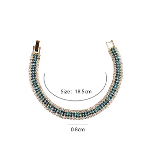 Elegant gold plated bracelet with blue and white crystals, 18.5cm long and 0.8cm wide