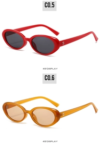 Detailed 45-degree angle view of vintage oval sunglasses in red and amber frames