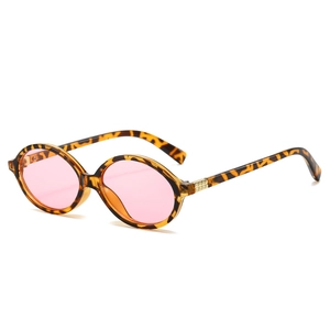 Oval tortoiseshell sunglasses with pink lenses and gold rivet accents on white background