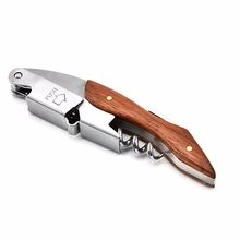 Detail of stainless steel waiter's friend corkscrew with wood inlay and push lever