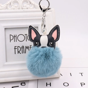 Detail shot of a cute French Bulldog PU leather charm with a soft blue fluffy pompom
