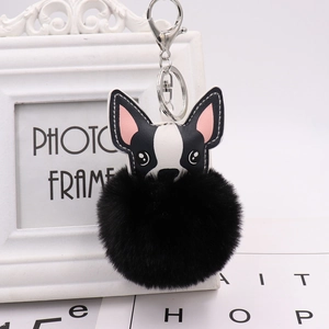 Detail of cute French Bulldog charm with a large fluffy black pompom on a silver keychain