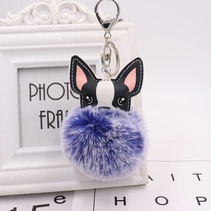 Close-up of cute French Bulldog keychain with purple pom-pom and leather head detail