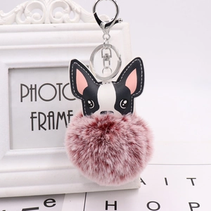 Detail of cute French bulldog plush keychain with pink pompom and silver lobster clasp