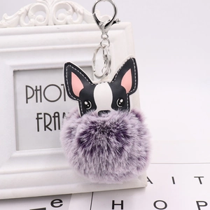 Close-up of French Bulldog PU leather charm with purple fluffy pom pom keychain detail