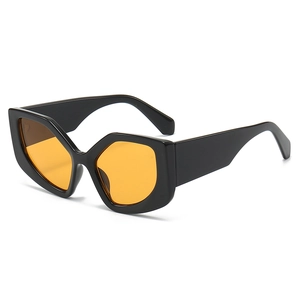 Stylish cat eye polygon sunglasses with black thick frames and orange transparent lenses