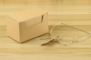 Eco-friendly kraft paper candy box with matching gift tag and natural twine cord