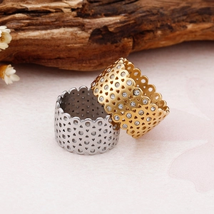 18K gold plated heart hollow rings set with white crystals on a wooden background
