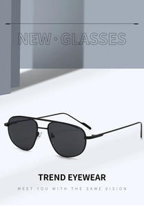 Detail of sleek black aviator sunglasses with thin metal frames and dark lenses
