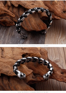 Detail view of gothic skull titanium steel bangle with black braided leather and vintage finish