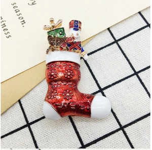 Detail of Christmas enamel brooches featuring nutcracker and holiday motifs on grid card