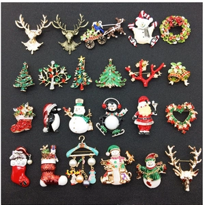 Detailed assortment of Christmas brooches featuring Santa, reindeer and tree designs