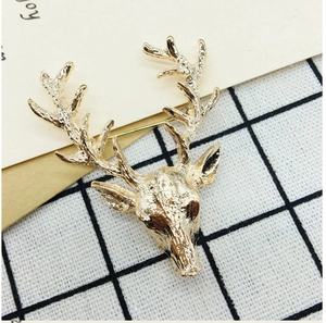 Detailed view of a golden deer head brooch featuring textured metal design on dark mesh