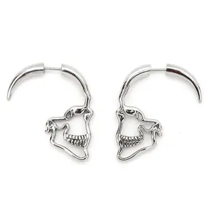 Detailed macro view of silver punk skull jawbone earrings with gothic spike design
