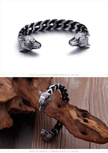 Detailed view of punk wolf head bangle with black braided leather and vintage steel finish
