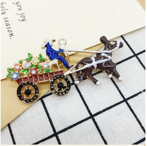 Macro detail of enamel horse carriage brooch with rhinestones and colorful floral patterns
