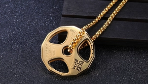 Macro shot of 316L steel dumbbell pendant with Think About Why You Started engraving