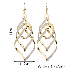 Detailed view of large gold spiral earrings showing 11cm length and weight specifications