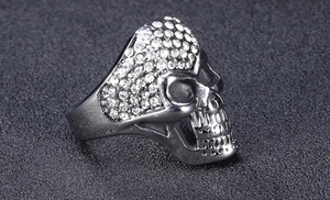 Macro shot of silver titanium steel skull ring with sparkling rhinestones detail