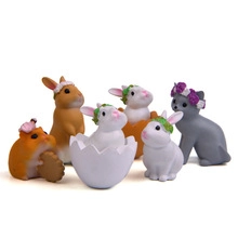Close-up of Japanese style resin animal figurines featuring kittens, rabbits and a hamster
